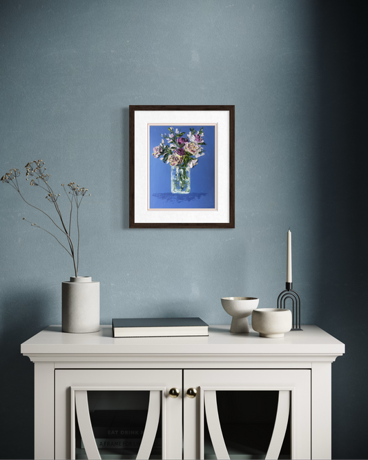 Fragrant Arrangements floral painting displayed in a dark frame above a white cabinet