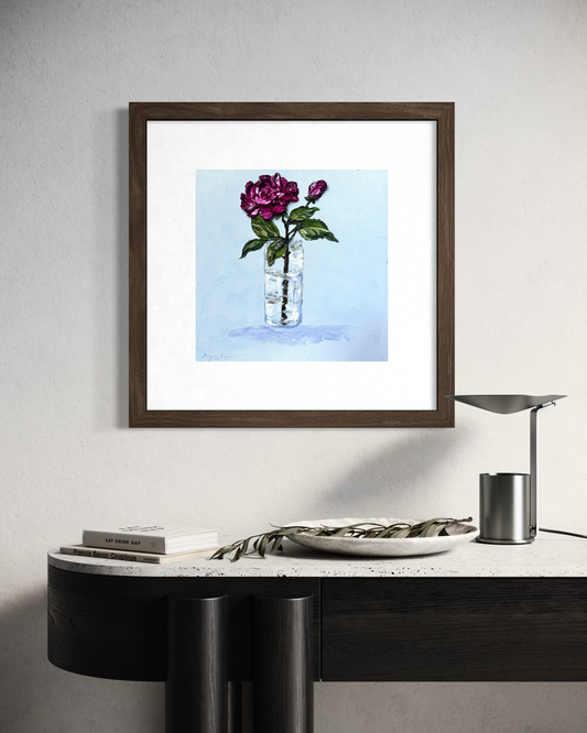 Eternal Rose floral painting displayed in a dark wood frame above a black console
